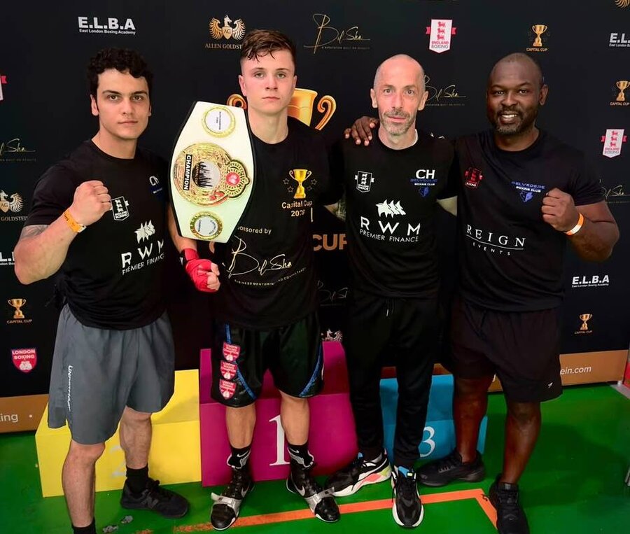 Championship belt win with the coaching team